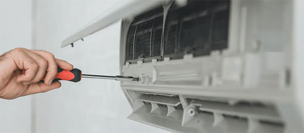 HVAC technician repairing a broken unit