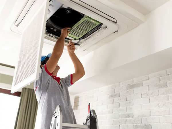 HVAC technician replacing an air filter