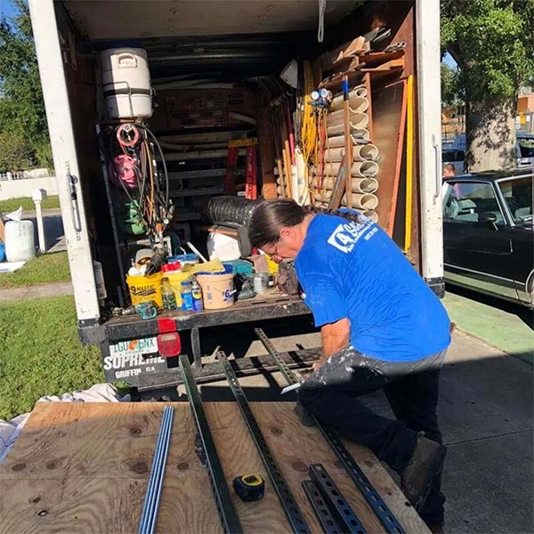 4 Seasons Air Conditioning and Heating technician preparing parts for installation