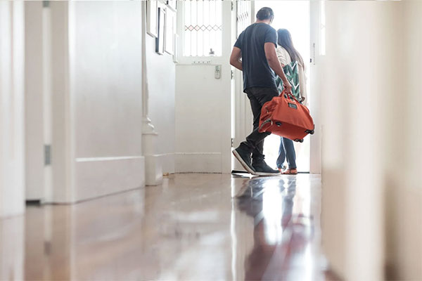 Homeowners exiting their house for a vacation